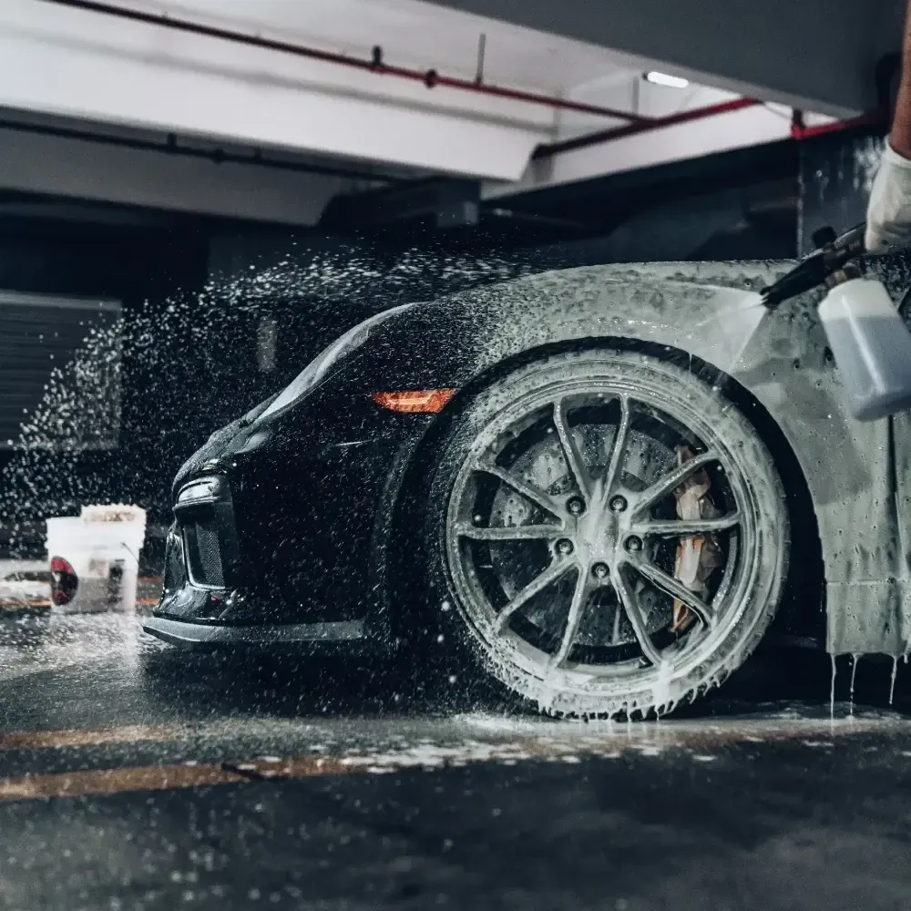 Porsche getting foam cannon sprayed onto it. It is used as a  banner for services in auto detailing