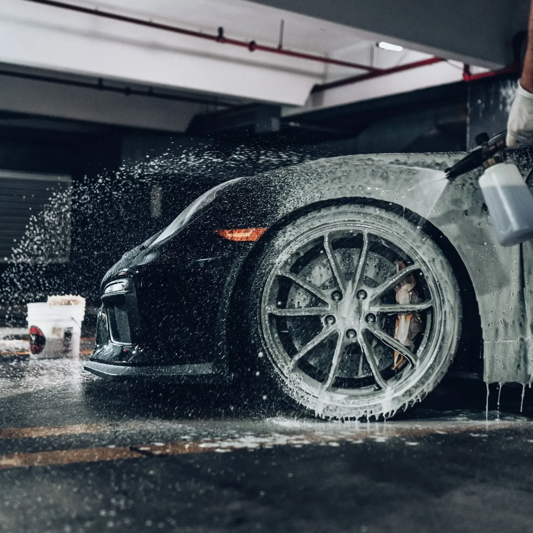 Porsche getting foam cannon sprayed onto it. It is used as a  banner for services in auto detailing